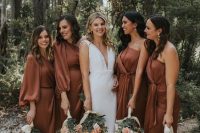 mismatching rust-colored midi bridesmaid dresses with long sleeves and without are perfect for a summer or fall wedding