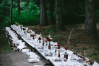 a boho woodland picnic with a low table, boho rugs, dark blooms, printed textiles and neutrals