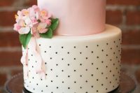 a cute wedding cake with a plain pink and black and white polka dot tier, pink blooms and greenery and ribbons is amazing for spring or summer