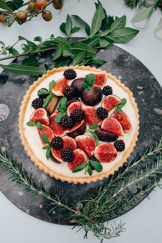 a large tart with custard, figs, blackberries and fresh mint is a delicious decadent dessert for a fall wedding