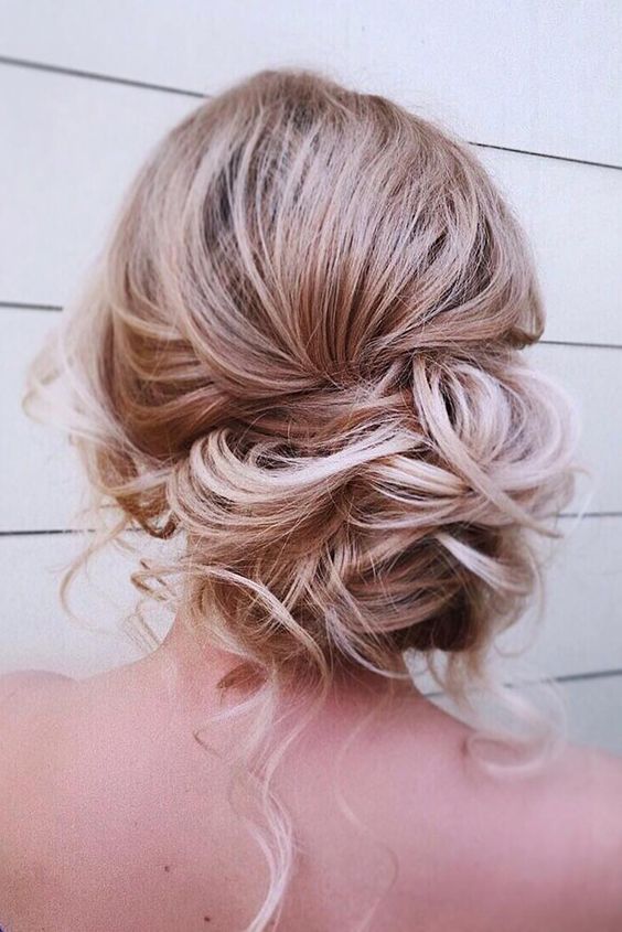 a messy low side bun with some curls down is a great idea to look chic and it will last long
