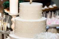 a neutral polka dot wedding cake with a monogram on top is classics for any neutral wedding, it looks very nice and pretty