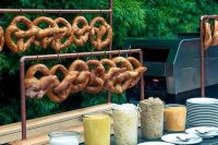 a pretzel stand with various kinds of dip and sauce is a lovely idea for a relaxed and informal dinner