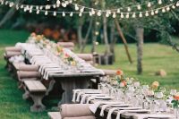 a stylish bbq rehearsal reception with lights over it, benches with burlap covers, bright blooms, neutral linens