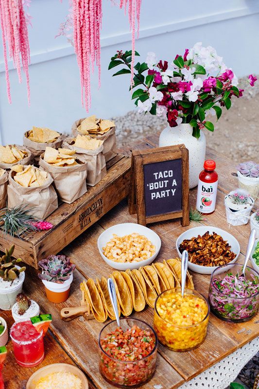 a taco station is a nice rehearsal food bar, decorate it with bright blooms and offer various fillings and sauces for tacos