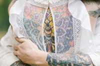 a white cuffed sleeve shirt show off bold and colorful groom’s tattoos in the best way possible