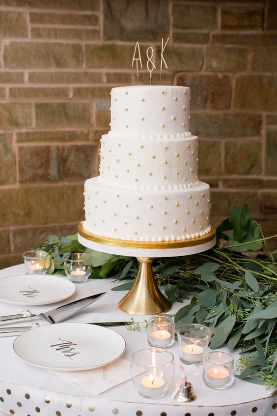 a cute wedding cake with monogram cake toppers