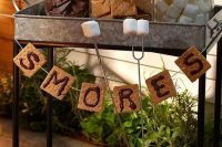 an s’mores station is a perfect idea for a bbq rehearsal dinner, it will break the ice and make people feel cozy
