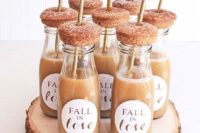 apple cider bottles and fresh donuts on top are nice wedding favors or late night snacks