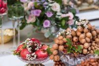 beautiful wedding arrangements with vintage crystal bowls, nuts, blooms and gruit are gorgeous for a refined wedding