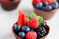 chocolate cups filled with blueberries, blackberries, strawberries and raspberries for a summer wedding