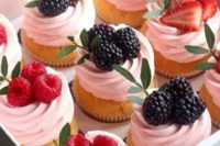 cupcakes with pink frosting and blackberries and raspberries are delicious for many weddings in any season