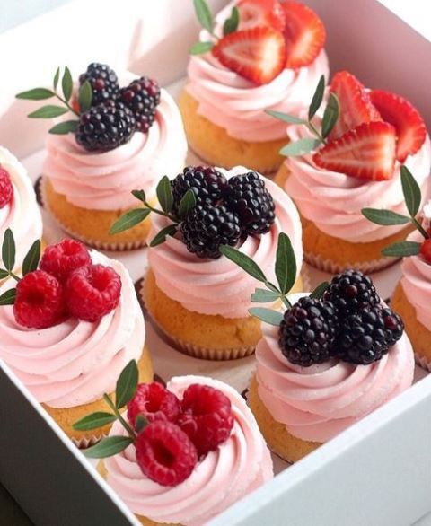 cupcakes with pink frosting and blackberries and raspberries are delicious for many weddings in any season