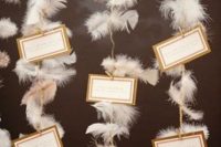 escort cards displayed on feather garlands are amazing for a 1920s wedding or wedding-related party