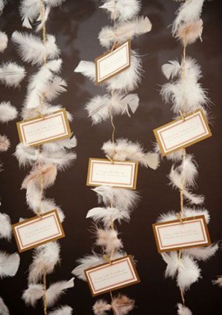 escort cards displayed on feather garlands are amazing for a 1920s wedding or wedding-related party