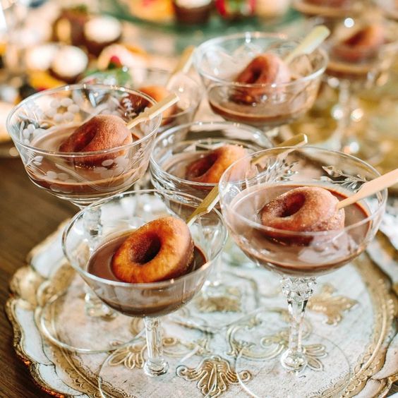 hot chocolate in elegant glasses and donuts are a tasty snack idea and will please those with a sweet tooth