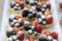 mini tartlets with custard, blackberries, blueberries and strawberries plus sugar powder for a summer wedding