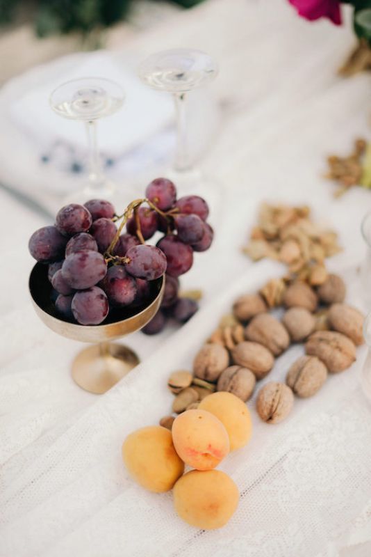 serving food Mediterranean style - grapes in a gold bowl, apricots and nuts on a tray are amazing for a wedding