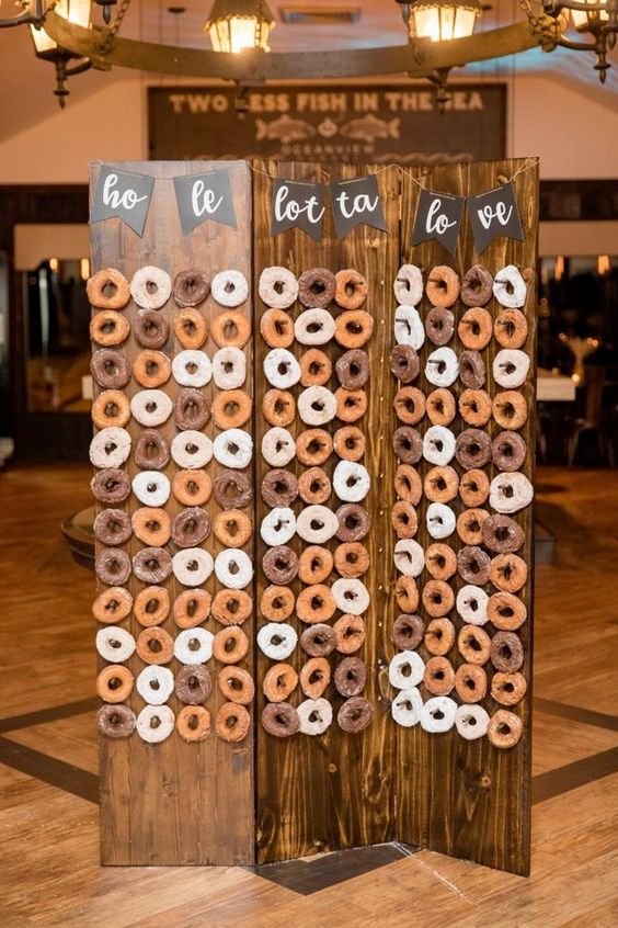stained wooden screen with a chalkboard banner as a donut wall - add ome greenery or blooms and voila