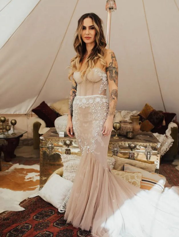 a strapless blush heavily embellished mermaid wedding dress with a train will make a bold statement