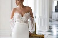 18 an incredibly sexy off the shoulder wedding dress with a lace bodice and puff sleeves and a plain skirt catches an eye with its deep neckline