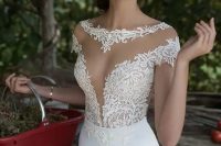 28 a jaw-dropping fitting wedding dress with an illusion bodice with a covered plunging neckline and a fitting skirt – this dress will accent all your curves at its best