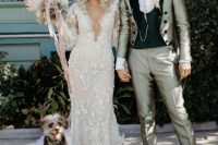 29 a lace mermaid wedding dress with a plunging neckline, long sleeves, statement earrings and a crown for a bold bridal look