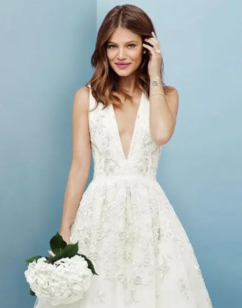 a sleeveless A-line wedding dress with lace applique and a plunging neckline is really sexy and catches an eye