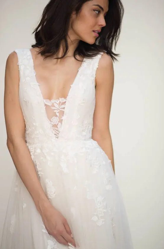 a beautiful A-line lace wedding dress with no sleeves and a plunging neckline with a lace cover - that's sexy but you still feel comfortable wearing this dress