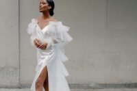 68 an unusual and sophisticated off the shoulder wedding dress with a draped bodice, ruffles all over, a long train and a thigh high slit for a sexy touch