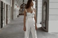 73 a sexy bridal look with a corset-like crop top and high waisted cropped trousers, white heels and pearl earrings