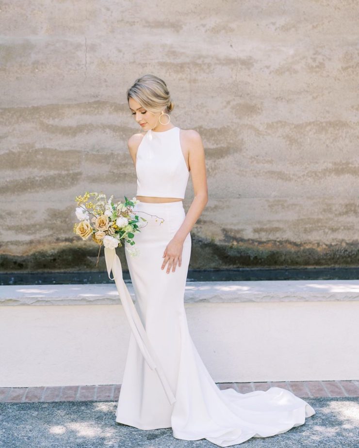 a minimalist, chic and sexy plain bridal separate with a halter neckline crop top and a mermaid skirt with a train is gorgeous