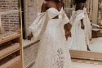 81 a lace two piece wedding dress wiht a crop top with long sleeves and a pleated maxi skirt with a train for a boho bride