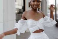 82 a modern white bridal separate with an off the shoulder top with puff sleeves and a high waisted pleated A-line skirt is fantastic