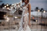 87 a sexy semi-sheer mermaid wedding dress with floral appliques all over the dress, a train and thick straps plus a deep neckline