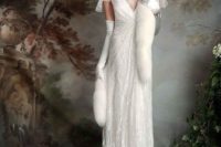 a 1920s inspired white sheath wedding dress with draperies, embellishments, cap sleeves and a train plus faux fur and tall gloves