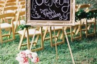 a beautiful and chic chalkboard sign in a refined gilded frame, on a stand and with a floral monogram is amazing