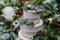 a beautiful naked wedding cake decorated with neutral blooms, greenery and succulents