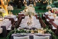 a beautiful spring garden wedding reception with lights and greenery is a gorgeous space
