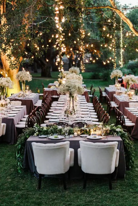 a beautiful spring garden wedding reception with lights and greenery is a gorgeous space