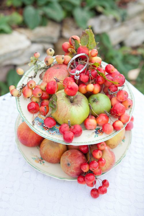 a beautiful vintage stand with apples, cherries and greenery will be a nice decoration for a rustic wedding, you can make one yourself