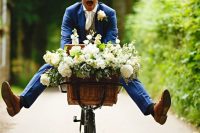 a bike with a basket filled with blooms and greenery is a fun and cool idea to rock at your wedding