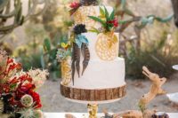 a boho wedding cake with painted dream catchers, bright blooms, feathers and succulents
