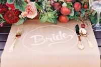 a bold wedding centerpiece of blush, burgundy blooms, greenery, berries and apples is a fantastic idea for a bright fall wedding