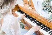 a bride playing the piano is a gorgeous idea, you may gift your couple a song or some music