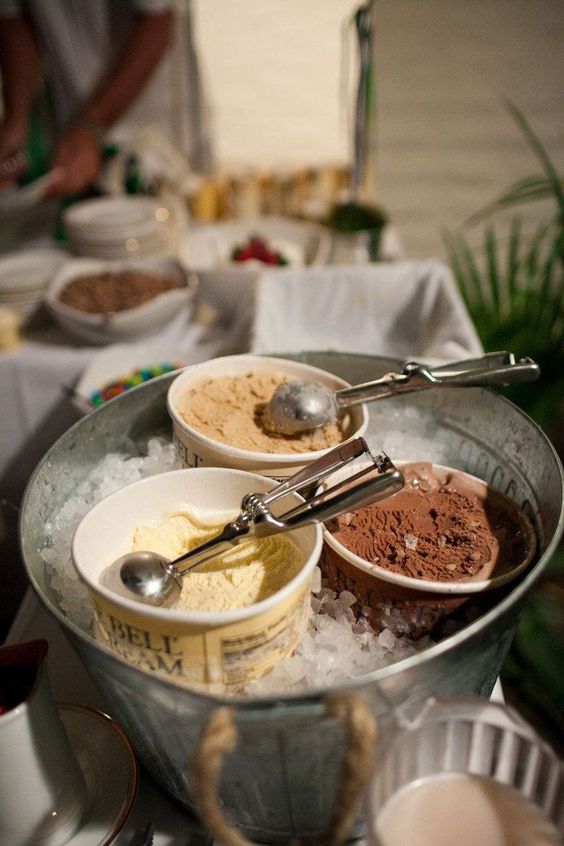 a bucket filled with ice and with various types of ice cream is a very cool and fresh idea to serve ice cream and sorbet at your wedding