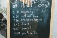 a chalkboard sign with the program of the day, on a stand with super bright blooms and greenery is amazing for a rustic space