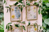 a delicate garden wedding seatign chart in blush, with flower glass parts and greenery is a cool solution