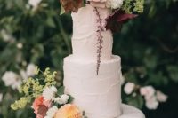 a fabulous garden wedding cake with textural buttercream, pastel blooms and greenery on top is a lovely idea