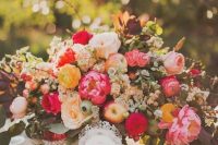 a gorgeous and lsuh wedding centerpiece of neutral, pink and yellow blooms, greenery, twigs and banches and apples is a fantastic idea for a fall wedding